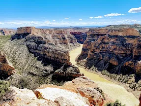 Bighorn Canyon from the rim, the green river far below between sheer banded walls
