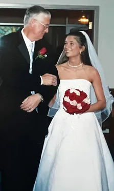 Emily on her father's arm before walking down the aisle, the two of them looking at each other