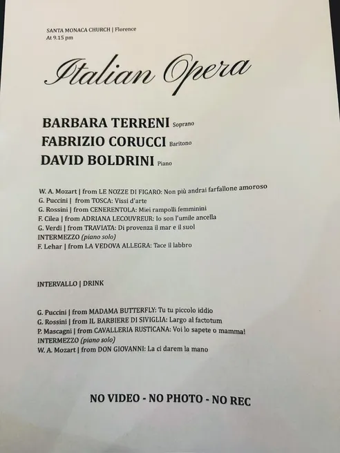 The concert programme for an Italian opera evening at Santa Monaca Church in Florence, listing arias by Mozart, Puccini, Rossini and Verdi