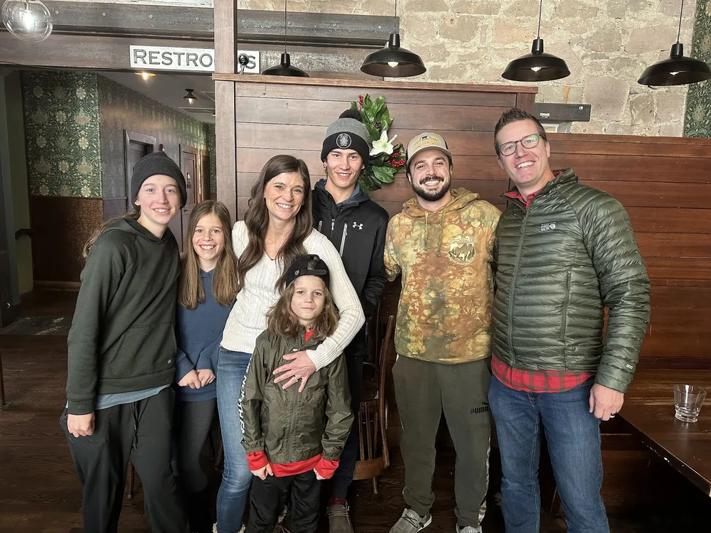 The whole family crowded in for a photograph with the musician Ian Munsick inside a stone and timber restaurant