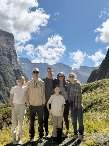 All six of them on a grassy track high in the Milford valley, sheer rock walls either side and cloud over the peaks