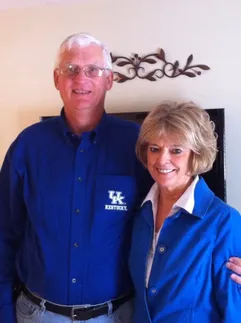 Emily's parents side by side, both in Kentucky blue, his shirt embroidered UK Kentucky